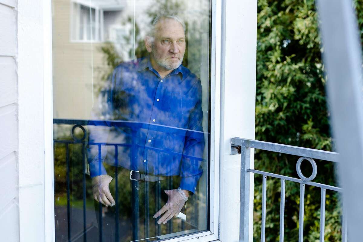 Carl Jaeger looks out of a window in his home on Friday, March 27, 2020, in San Francisco, Calif. Mr. Jaeger, who is an Airbnb host in San Francisco, is facing financial uncertainty as Airbnb cancellations continue due to the coronavirus pandemic.