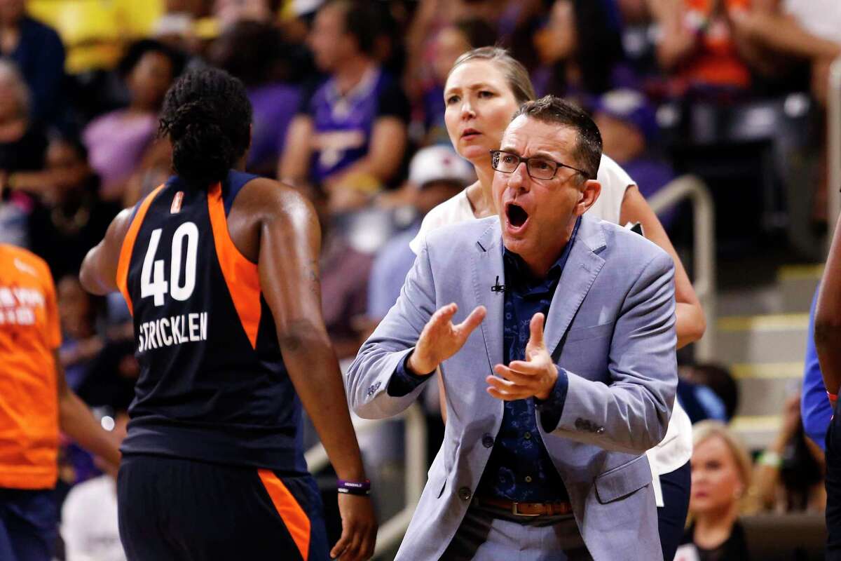 Connecticut Sun head coach Curt Miller, right, greets his players during a timeout in the second half of Game 3 of a WNBA playoff game against the Los Angeles Sparks in September.