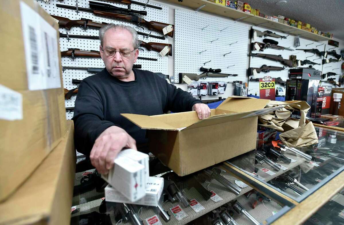 Arnie Willhite, owner of Connecticut Sporting Arms LLC of North Branford, opens a delivery of ammunition and other product Tuesday to restock his shelves.