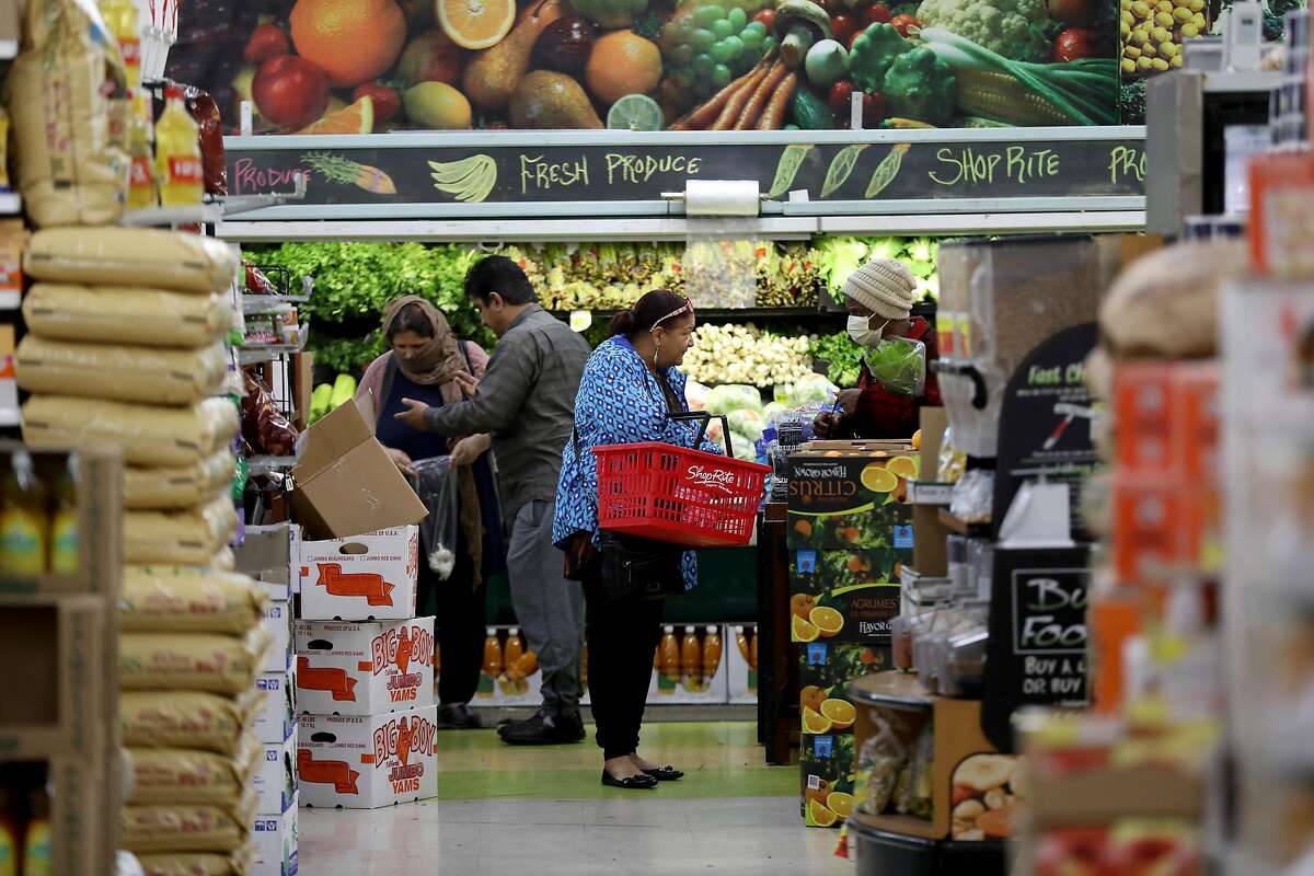 Customers shop inside Shop Rite, located at 5800 Bancroft Ave., on Thursday, March 26, 2020, in Oakland, Calif.