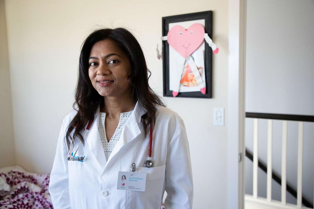 Dr. Prarthana Parmani, a pediatrician with Heal, conducts telemedicine from a makeshift office at home Thursday, March 26, 2020, in Sunnyvale, Calif.