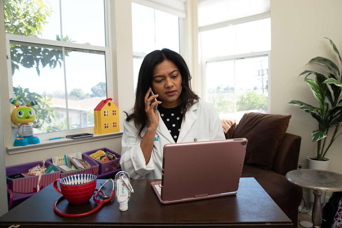 Dr. Prarthana Parmani, a pediatrician with Heal, conducts telemedicine from a makeshift office at home Thursday, March 26, 2020, in Sunnyvale, Calif.