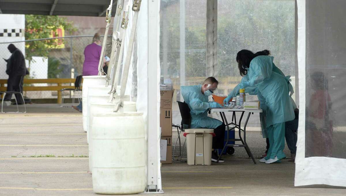 Medical personnel work inside a tent set up in the back lot of Legacy Community Health on N. Eleventh Street in Beaumont offering COVID-19 testing after screening and also doing flu testing. The clinic is the first private screening unit set up in Jefferson County. Photo taken Wednesday, March 18, 2020 Kim Brent/The Enterprise