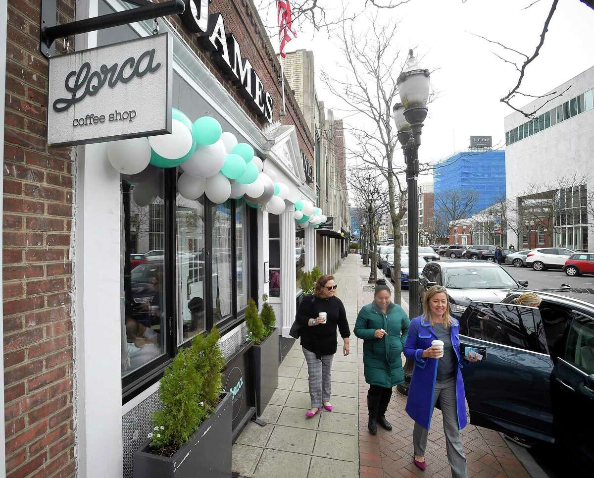 From left, Keenan McMahon, AnaVivian Estrella and Gina Mello leave Lorca in Stamford, Connecticut on March 11, 2020 with their cups of freshly brewed coffee.