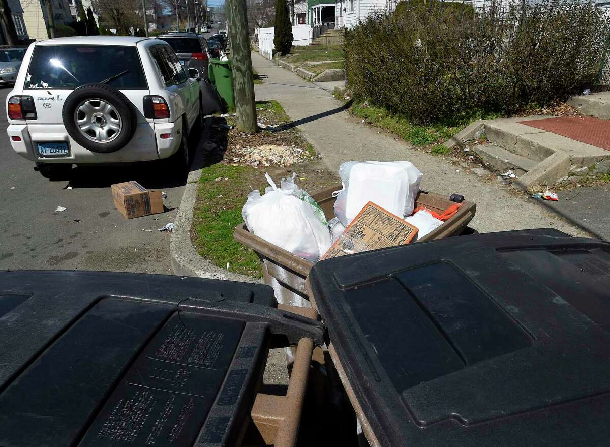 Trash and recycling bins are photograph on March 27, 2020 in a residential neighborhood in Stamford, Connecticut.