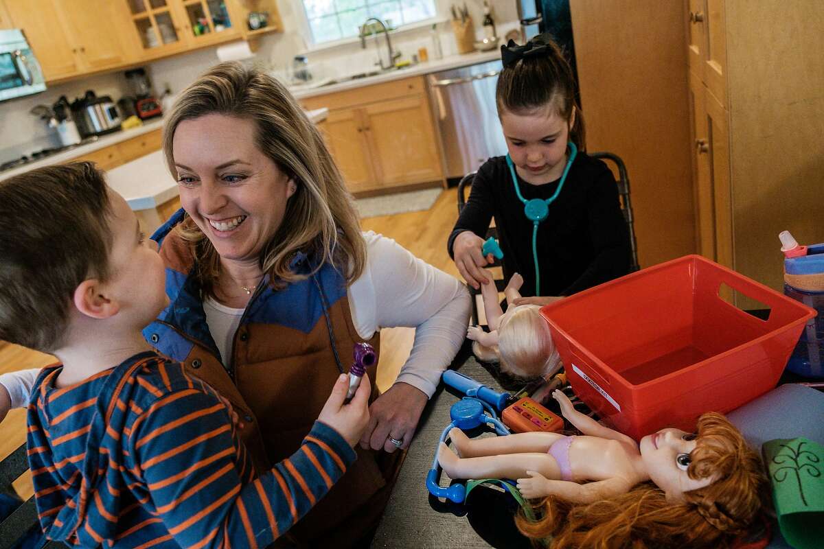 Cana Jenkins plays with her two children Samara, 5, and Isaac, 3, at their in Penngrove, Calif. on Saturday March 28, 2020. Jenkins is a nurse practitioner working in the ER at UCSF treating patients in the COVID-19 tent.