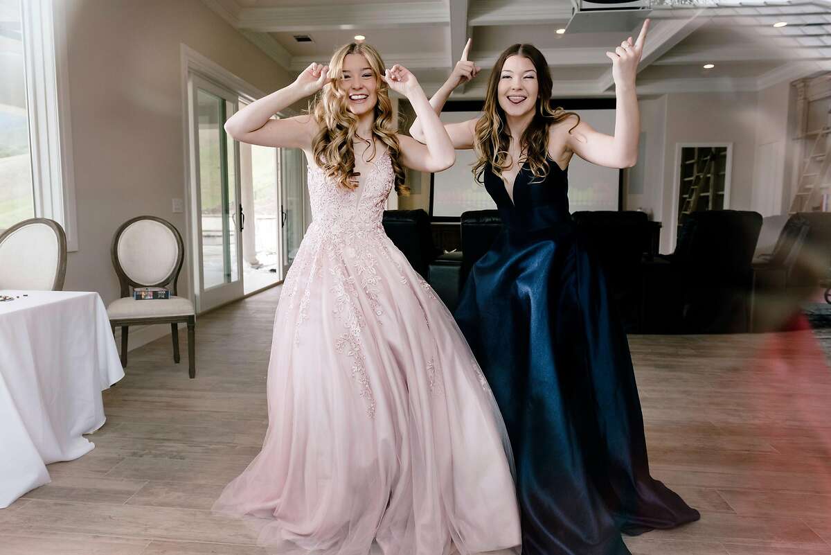 Natalie Reese, left, and her twin sister Brooke Reese film TikTok videos of themselves celebrating their canceled prom from their home in Danville, Calif, on Saturday, March 28, 2020.