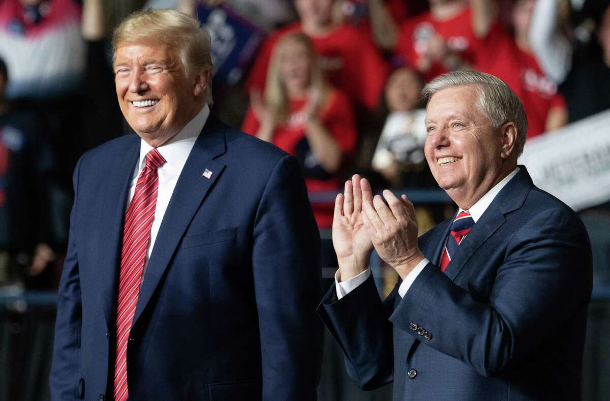 US president Donald Trump (L) smiles as he stands alongside US Senator Lindsey Graham (R), Republican of South Carolina, during a Keep America Great campaign rally for US President Donald Trump at the North Charleston Coliseum in North Charleston, South Carolina, February 28, 2020. (Photo by SAUL LOEB / AFP) (Photo by SAUL LOEB/AFP via Getty Images)