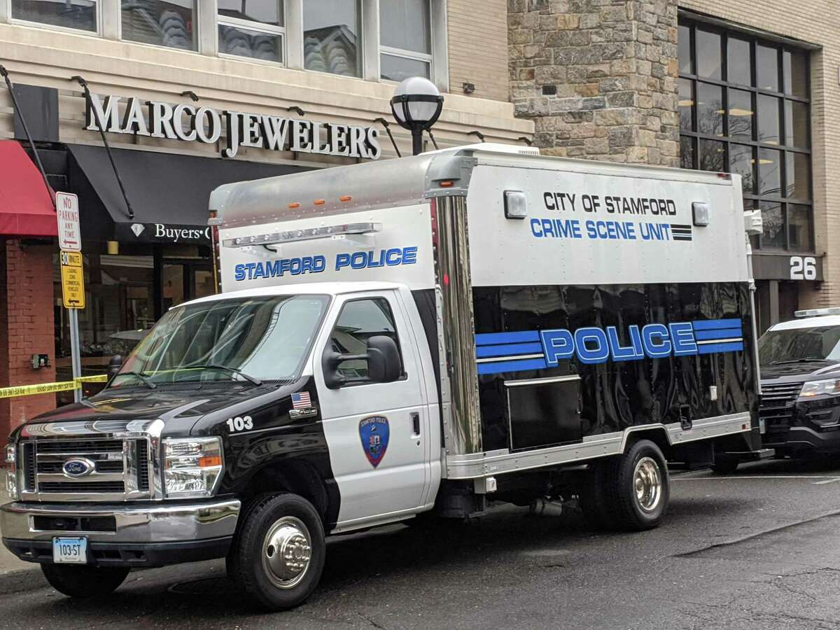 Stamford police vehicles are parked outside Marco Jewelers on 6th Street Sunday afternoon. Police say the owner of the store was shot and killed during an afternoon robbery on Saturday.