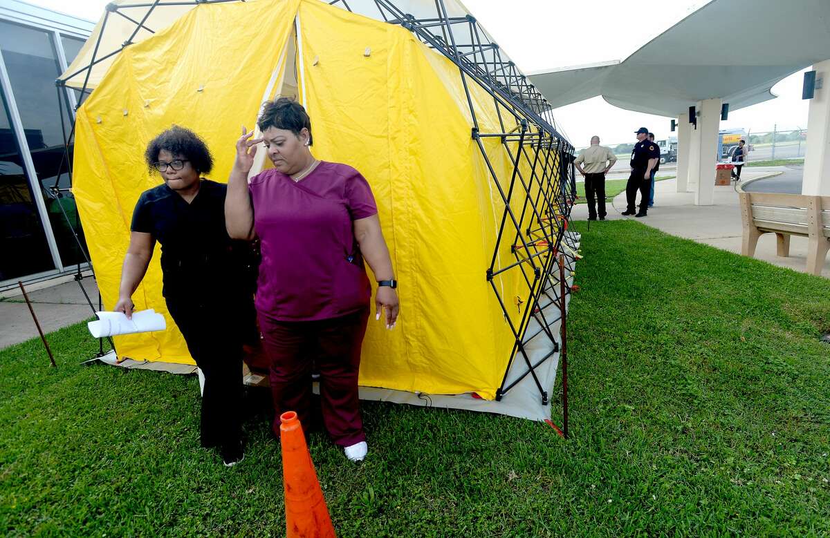 Medical personnel check out one of their tent facilities after representatives from multiple Southeast Texas counties annnounced the opening of a drive-thru testing unit for COVID-19 at Jack Brooks Regional Airport Monday. Photo taken Monday, March 23, 2020 Kim Brent/The Enterprise