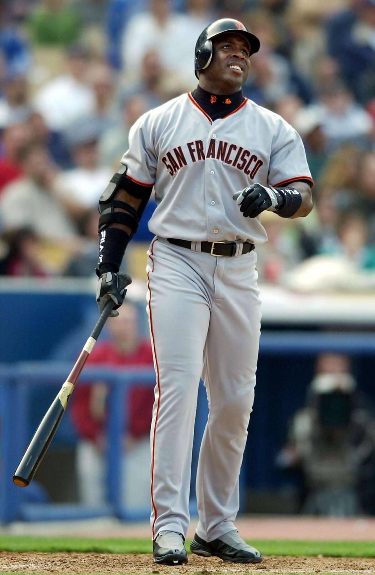 San Francisco Giants slugger Barry Bonds looks at his solo home run shot to right field off of Los Angeles Dodgers pitcher Omar Daal for his second home run of the game during the seventh inning of their season opener at Dodger Stadium Tuesday, April 2, 2002, in Los Angeles. (AP Photo/Kevork Djansezian)