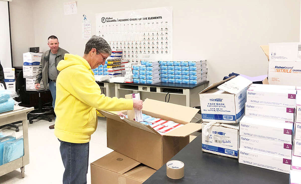 Skidmore College Director of Health Services Patricia Bosen and Director of Campus Safety Timothy Munro, left, prepare donations for Saratoga Hospital. The college donated thousands of gloves and other protective gear to boost the local community's capacity to deal with the outbreak. The donation of supplies, large enough to fill two pickup trucks, included around 20,000 protective gloves, 20 N95 masks, disinfectants and other essential items. (Courtesy Skidmore College)