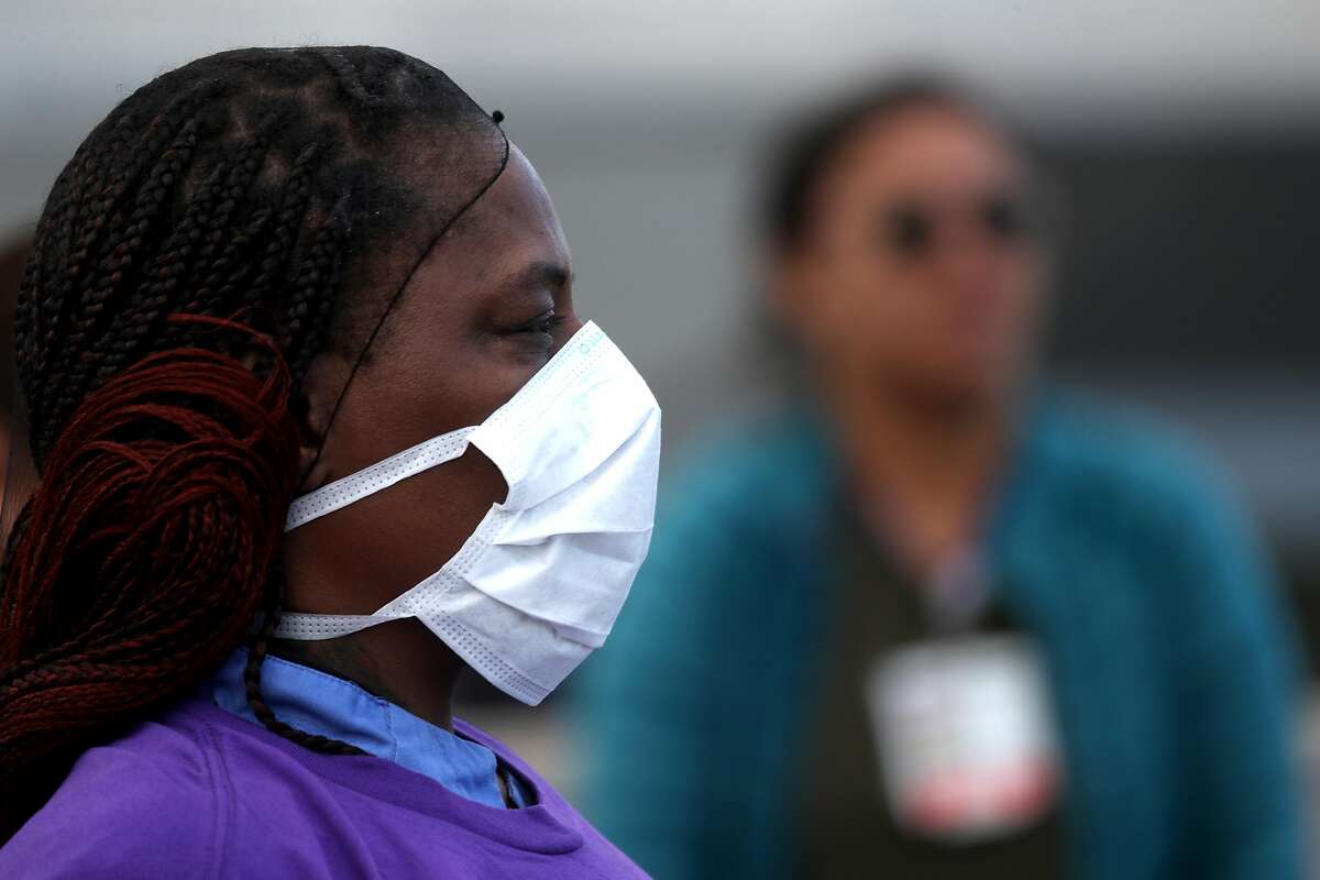OAKLAND, CALIFORNIA - MARCH 26: Alameda Health System nurses, doctors and workers wear protective equipment during a protest in front of Highland Hospital on March 26, 2020 in Oakland, California. Dozens of health care workers with Alameda Health System staged a protest to demand better working conditions and that proper personal protective equipment be provided in the effort to slow the spread of COVID-19. (Photo by Justin Sullivan/Getty Images)