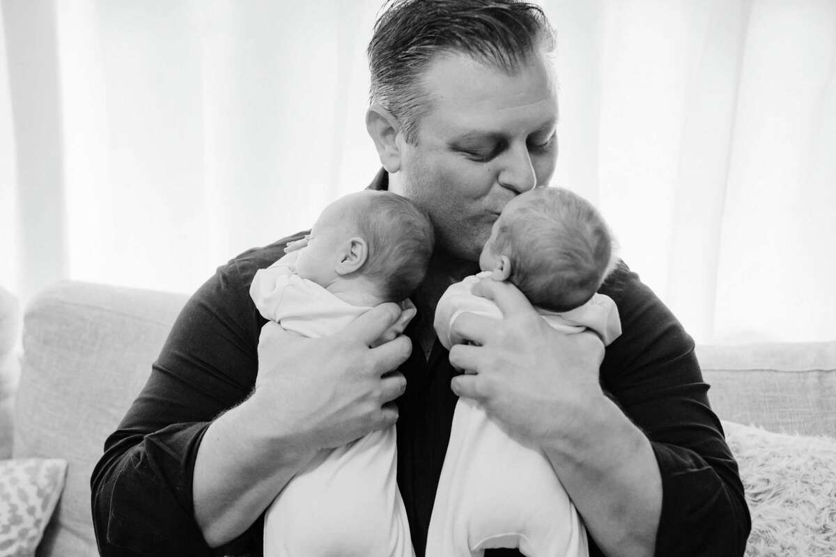 Chris Tillett of Wilton holds his twin sons. This picture was taken before Chris, 45, was hospitalized with COVID-19. He was released from Danbury Hospital on March 23.