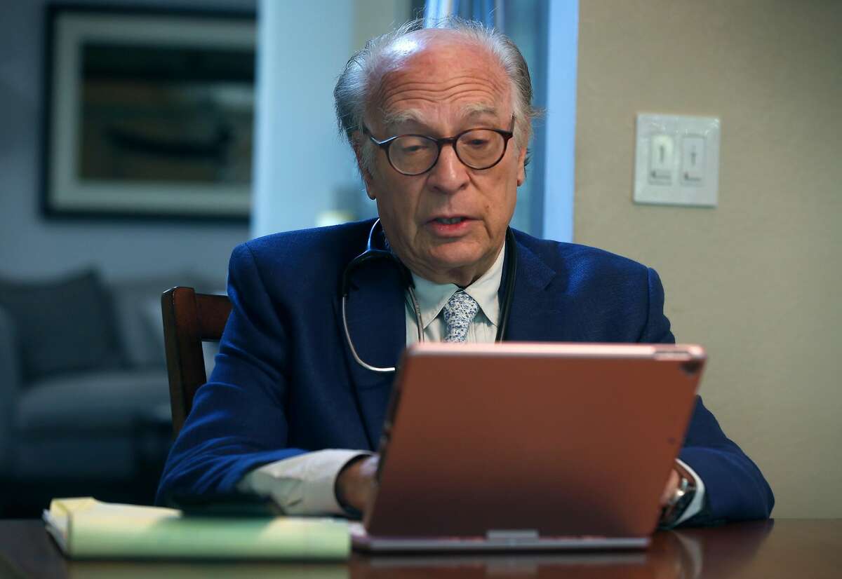 Dr. Neil Handelman meets with a patient remotely during a telemedicine appointment to discuss and diagnose possible coronavirus symptoms from his home in San Rafael, Calif. on Friday, March 27, 2020.