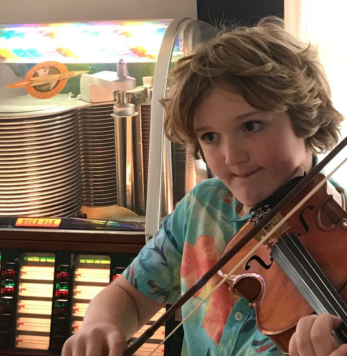 Nine-year-old Ridgefielder Austin Wakin is traveling to people's homes to play Happy Birthday, outside, on his violin.
