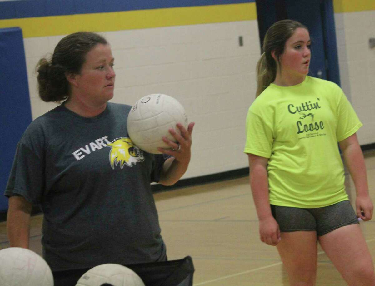 Evart coach Amanda Brown (left), pictured here working with her volleyball team last summer, hopes to be coaching the softball squad this spring. (Pioneer file photo)