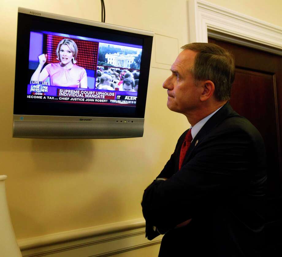Del. Richard L. Anderson, R-Prince William reacts to the news that the Supreme Court upheld the Obama healthcare reform law from Megyn Kelly, America Live anchor on the Fox News channel, as he watches in the Virginia State Capitol in Richmond, Va. Thursday, June 28, 2012. (AP Photo/Richmond Times-Dispatch, Bob Brown). Photo: BOB BROWN / Associated Press / RICHMOND TIMES-DISPATCH