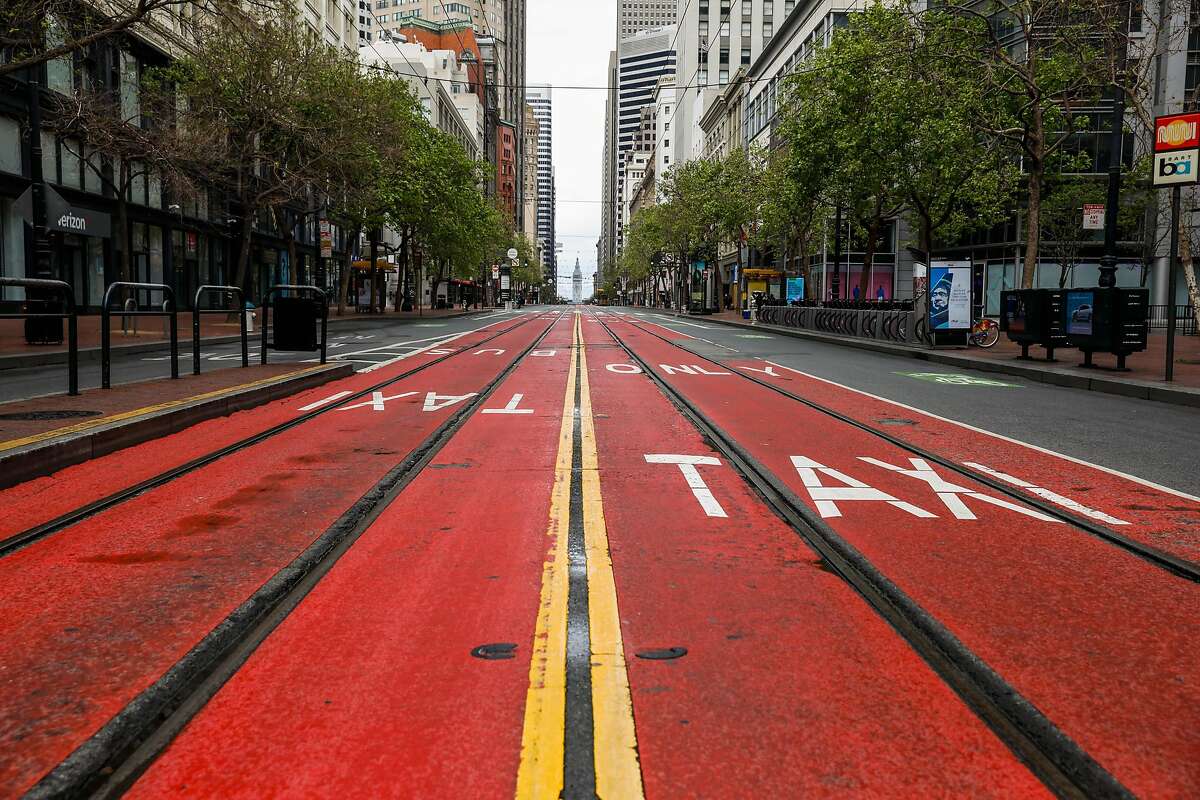 An empty Market Street during the second week of shelter in place orders due to the coronavirus on Sunday, March 29, 2020 in San Francisco, California. Starting Monday, there will be no more subway or light rail service in San Francisco.