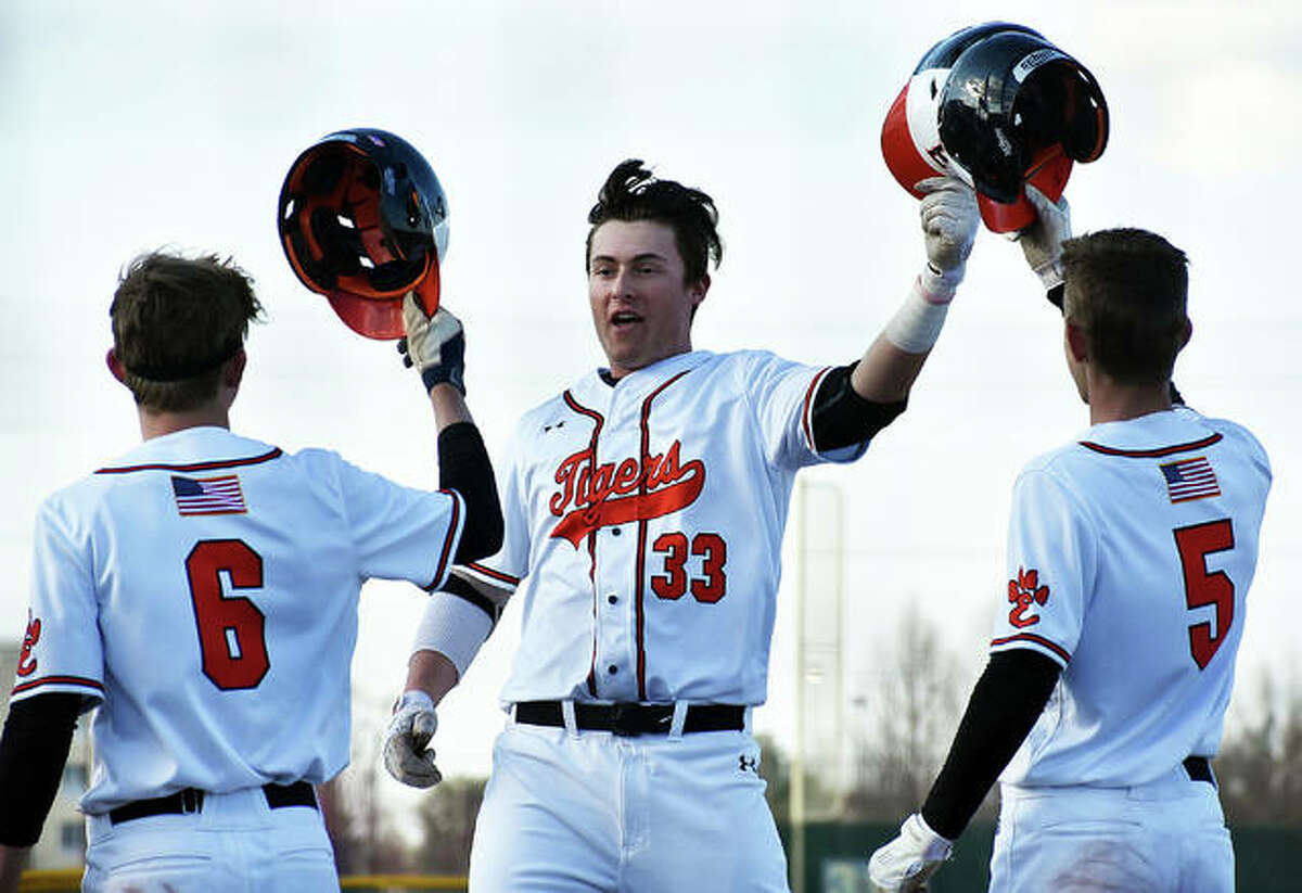 Edwardsville senior Drake Westcott is congratulated at home plate by his teammates after hitting a 3-run home run against Granite City during a regular-season game last year.