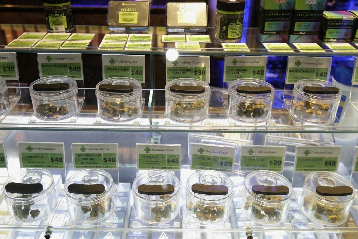 Various marijuana buds for sale are displayed at The Green Cross cannabis dispensary in San Francisco, Wednesday, March 18, 2020. As about 7 million people in the San Francisco Bay Area are under shelter-in-place orders, only allowed to leave their homes for crucial needs in an attempt to slow virus spread, marijuana stores remain open and are being considered "essential services."