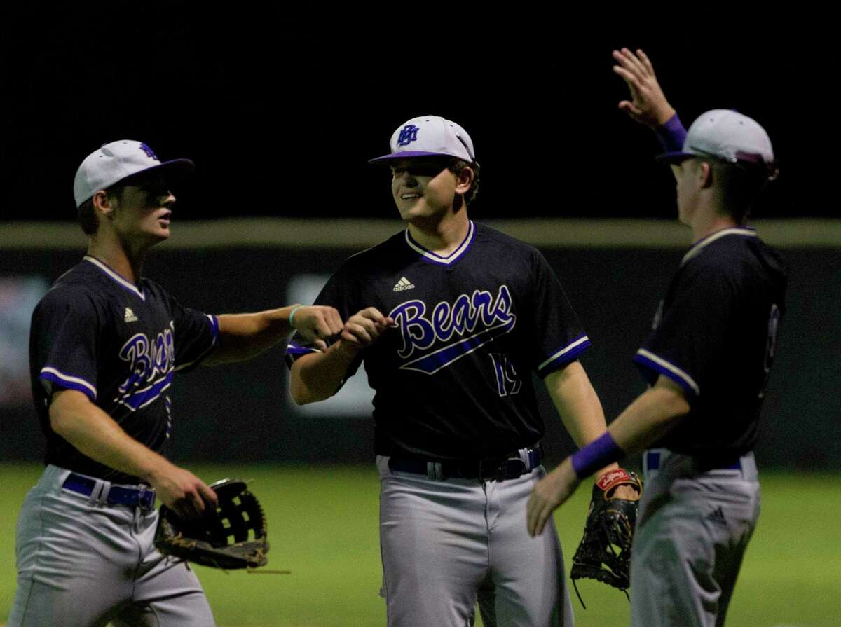 Montgomery starting pitcher Dillon Smith (10) gets a high-five from first baseman Cole Morris (19) and Grant Brown after the fifth inning of a District 20-5A high school baseball game at Caney Creek High School, Tuesday, April 23, 2019, in Grangerland.