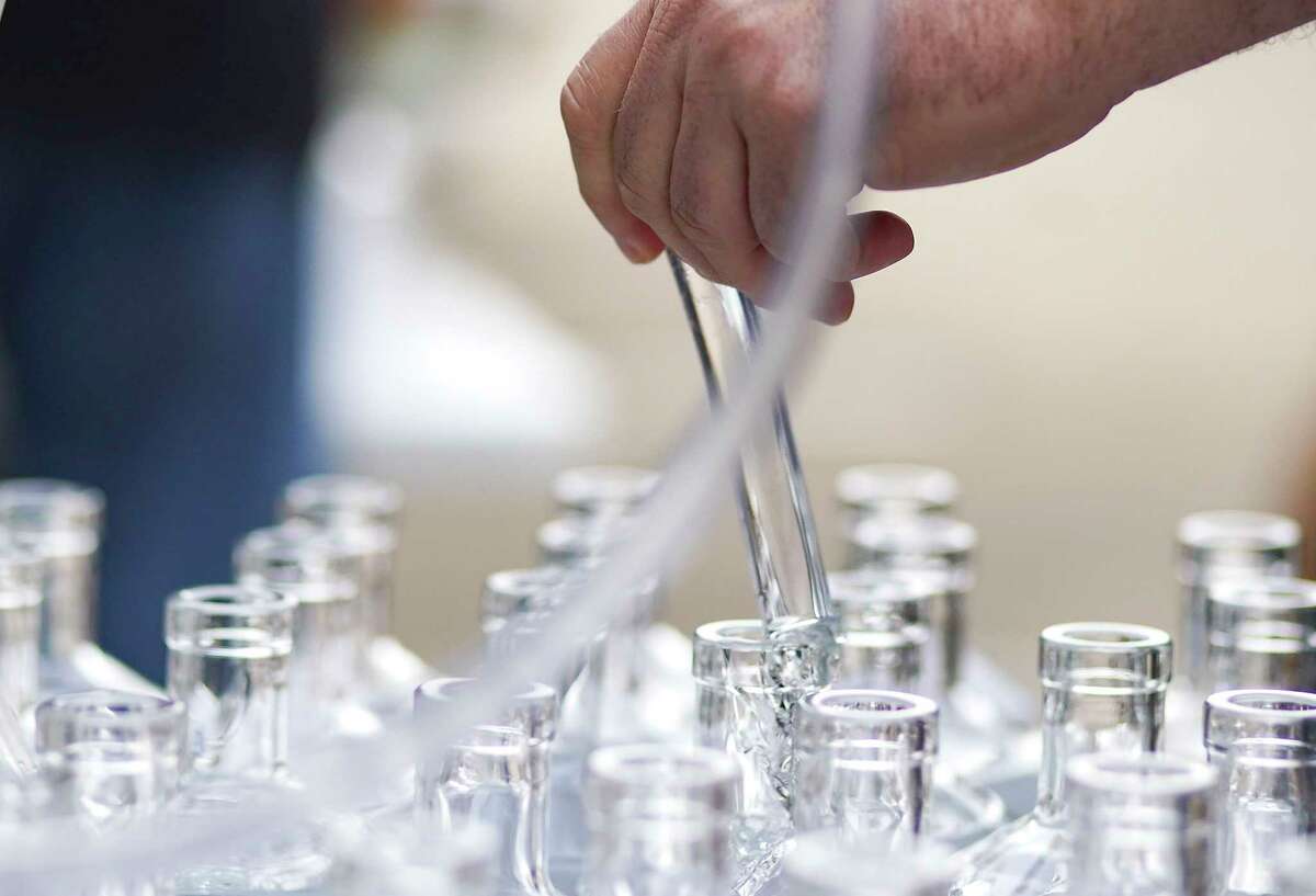 Whitmeyer's Distillery in Houston adapted its production line to make hand sanitizer and they're filling whisky bottles with it.