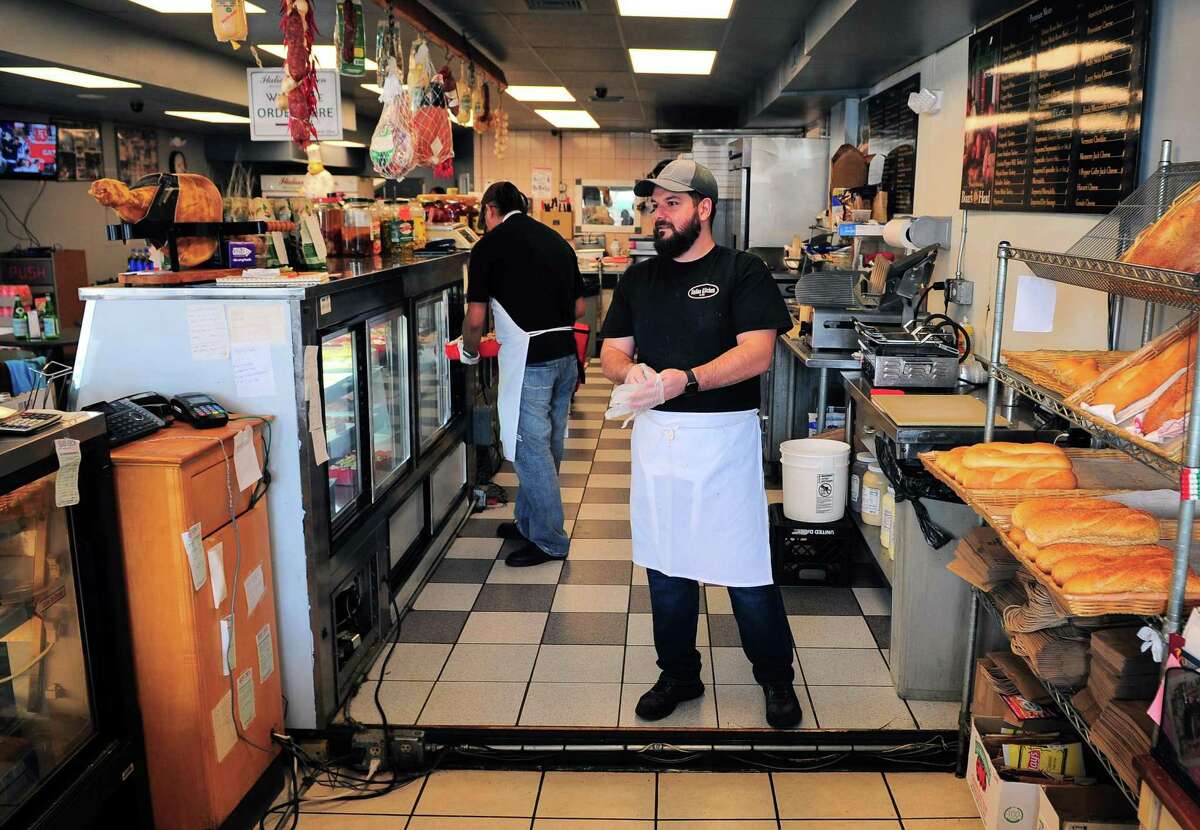 Italian Kitchen owner Dominick Giresi gets ready to prepare an order at his shop recently in Fairfield, Conn. Although places like Italian Kitchen remains open for business, some of Fairfield's restaurants are not faring well during the coronavirus closedown.