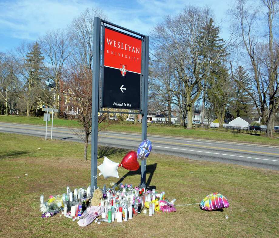 Candles are set up under the Wesleyan University sign at the corner of High Street and Washington Street in Middletown, the site of a hit-and-run March 4 which took the life of Brooke Rich, a Middletown mother and Wesleyan dining services worker who was crossing the road. Photo: Hearst Connecticut Media File Photo