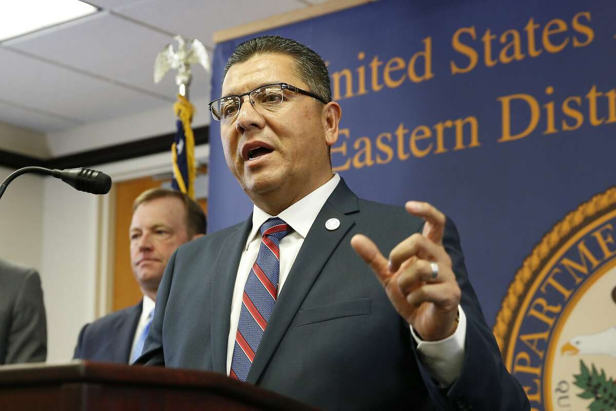 Ralph Diaz, the Secretary of the California Department of Corrections and Rehabilitation, answers questions concerning the charges against leaders of the white supremacist prison gang, the Aryan Brotherhood, during a news conference in Sacramento, Thursday, June 6, 2019. Aryan Brotherhood members and associates are accused of running a criminal enterprise using contraband cellphones, encrypted chats, text messages, multimedia messages and email.The charges detail five slayings and accuse an attorney of helping smuggle drugs and cellphones to aid the white supremacist gang. At left is McGregor Scott, the United States Attorney for the Eastern District of California. (AP Photo/Rich Pedroncelli)