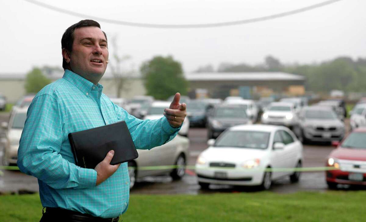 Pastor Chris Gober preaches during a drive-in style service at First Montgomery Baptist Church, Sunday, March 22, 2020, in Montgomery. More than 200 parishioners attended the service.