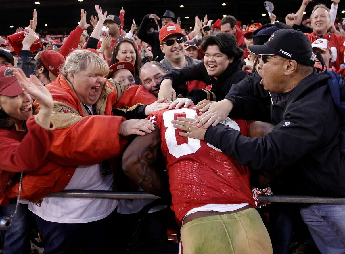 49ers Vernon Davis celebrates with fans near the end of the game, as the San Francisco 49ers beat the New Orleans Saints 36-32, in the NFC divisional playoffs, on Saturday Jan. 14, 2012, in San Francisco, Ca.