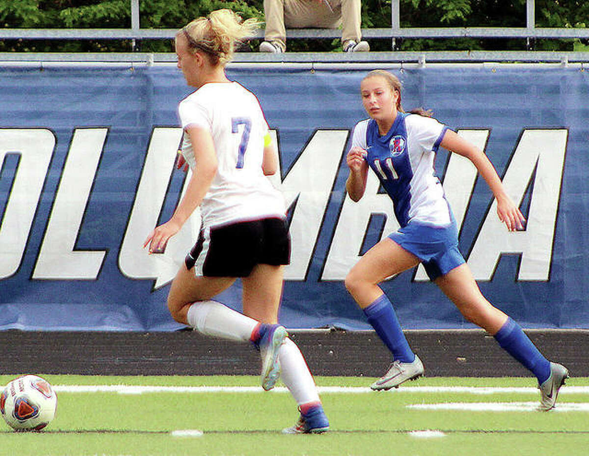 Macie Lucas of Roxana, right, gives chase against Columbia’s Taylor Parks during the 2018 Columbia Class1A Sectional Tournament. Lucas scored 16 goals and had 18 assists. A junior this season, Lucas is one of the standouts heading into the season, which is now in doubt because of the shutdown of spring sports because of the coronavirus.