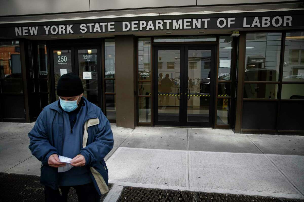 FILE - In this March 18, 2020 file photo, visitors to the Department of Labor are turned away at the door by personnel due to closures over coronavirus concerns. The coronavirus pandemic has already hurt many households financially. A Americans have been hit with layoffs, furloughs and reduced hours across the country. Those who have not are still facing massive economic uncertainty. Experts say it's more important than ever to manage your budget, reach out to lenders and seek protections available to those hit by the economic impact of the virus. (AP Photo/John Minchillo, File)
