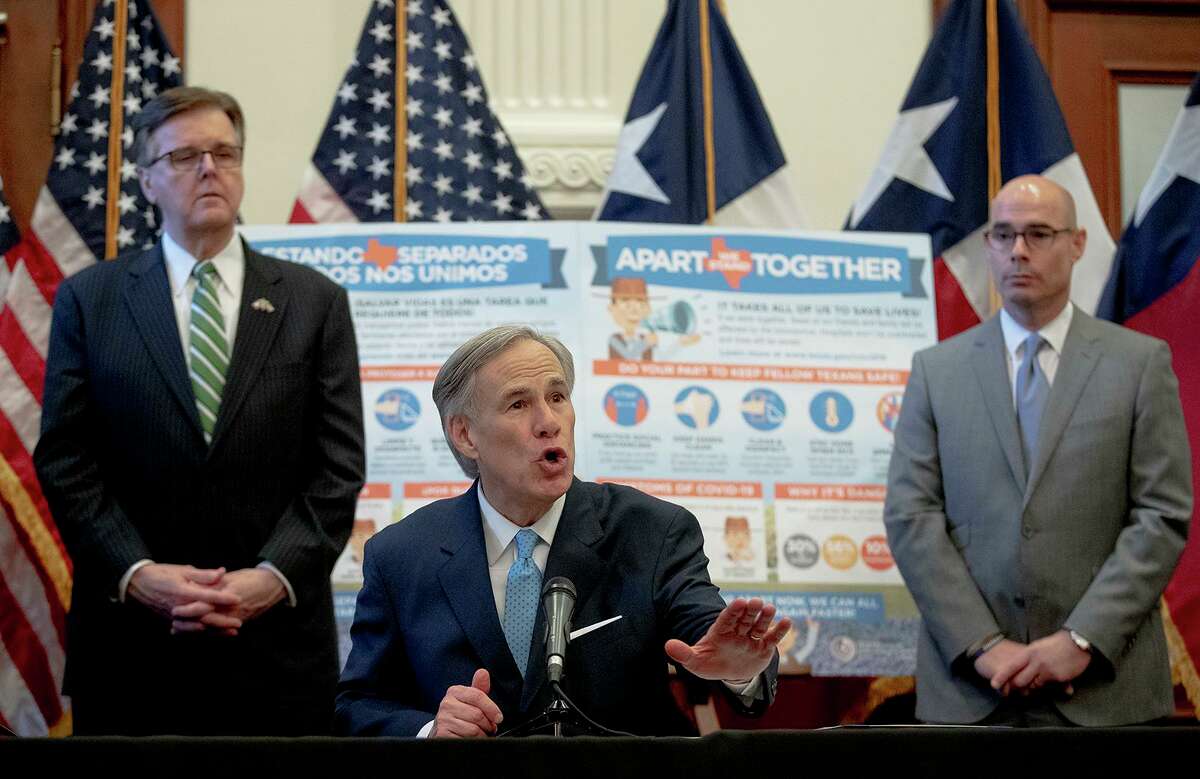 Texas Gov. Greg Abbott, flanked by Lt. Gov. Dan Patrick, left, and House Speaker Dennis Bonnen, speaks during a press conference at the state Capitol about the state's response to the coronavirus on Tuesday, March 31, 2020, in Austin, Texas. (Nick Wagner/Austin American-Statesman via AP)