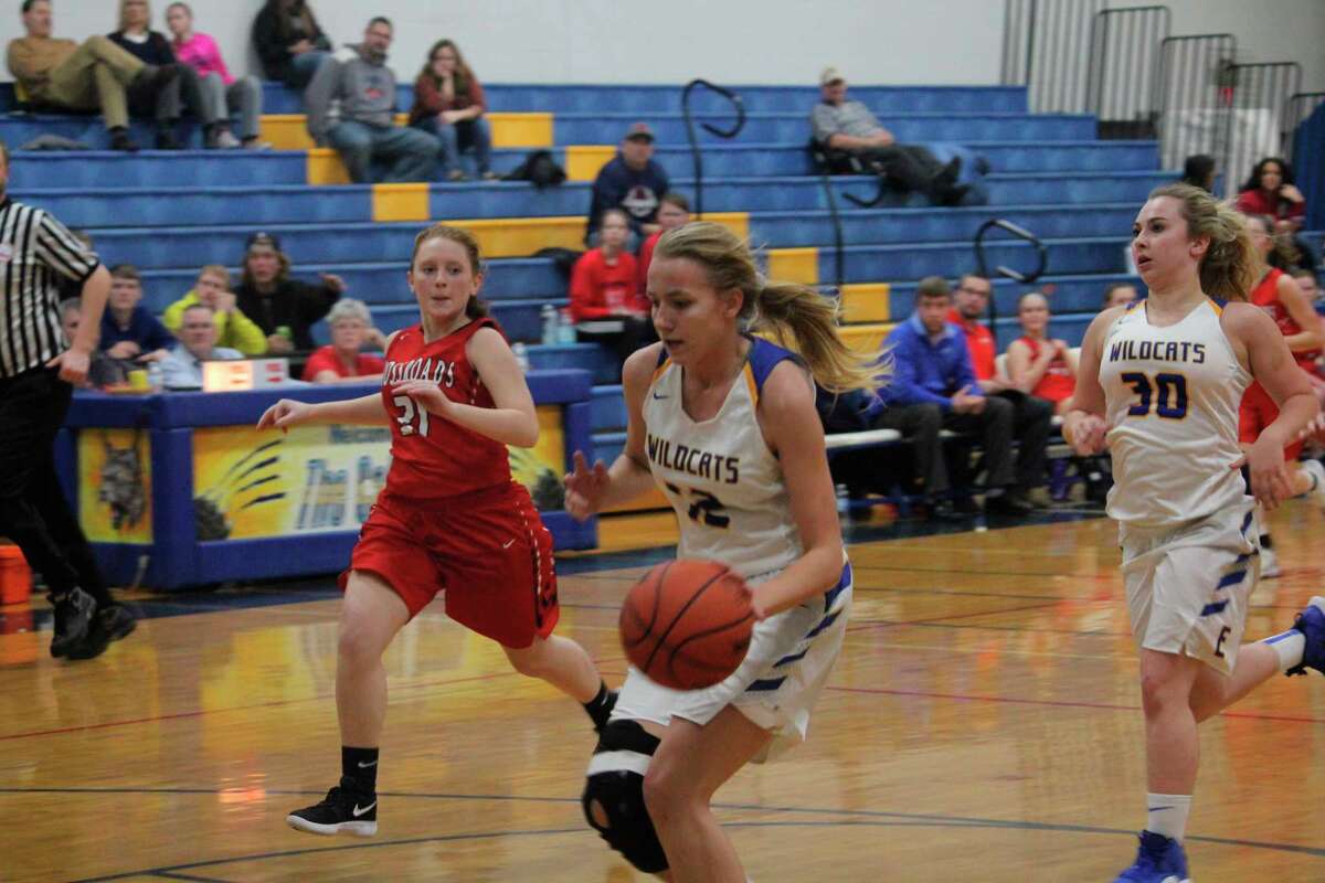 Kara Henry (with ball) was among Evart's top basketball players this season. (Herald-Review file photo)