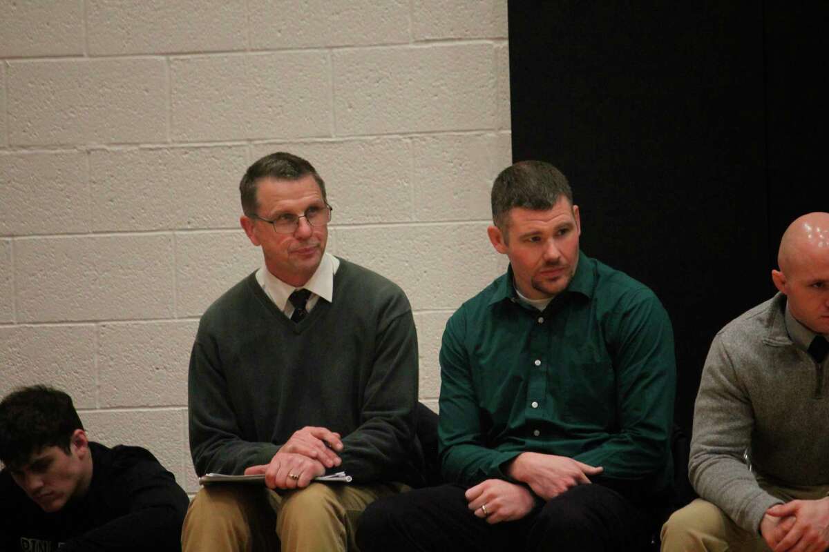 Pine River coach Tim Jones (left) and assistant Terry Martin watch a match during the regular season. (Herald Review photo/John Raffel)