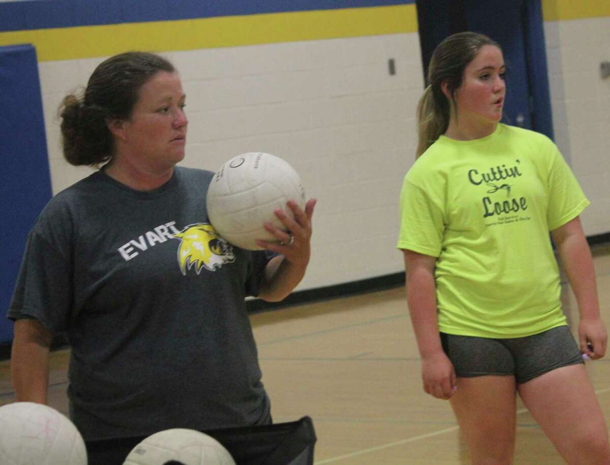 Evart softball coach Amanda Brown (left) is pictured here working with the volleyball team last summer. (Herald Review file photo)