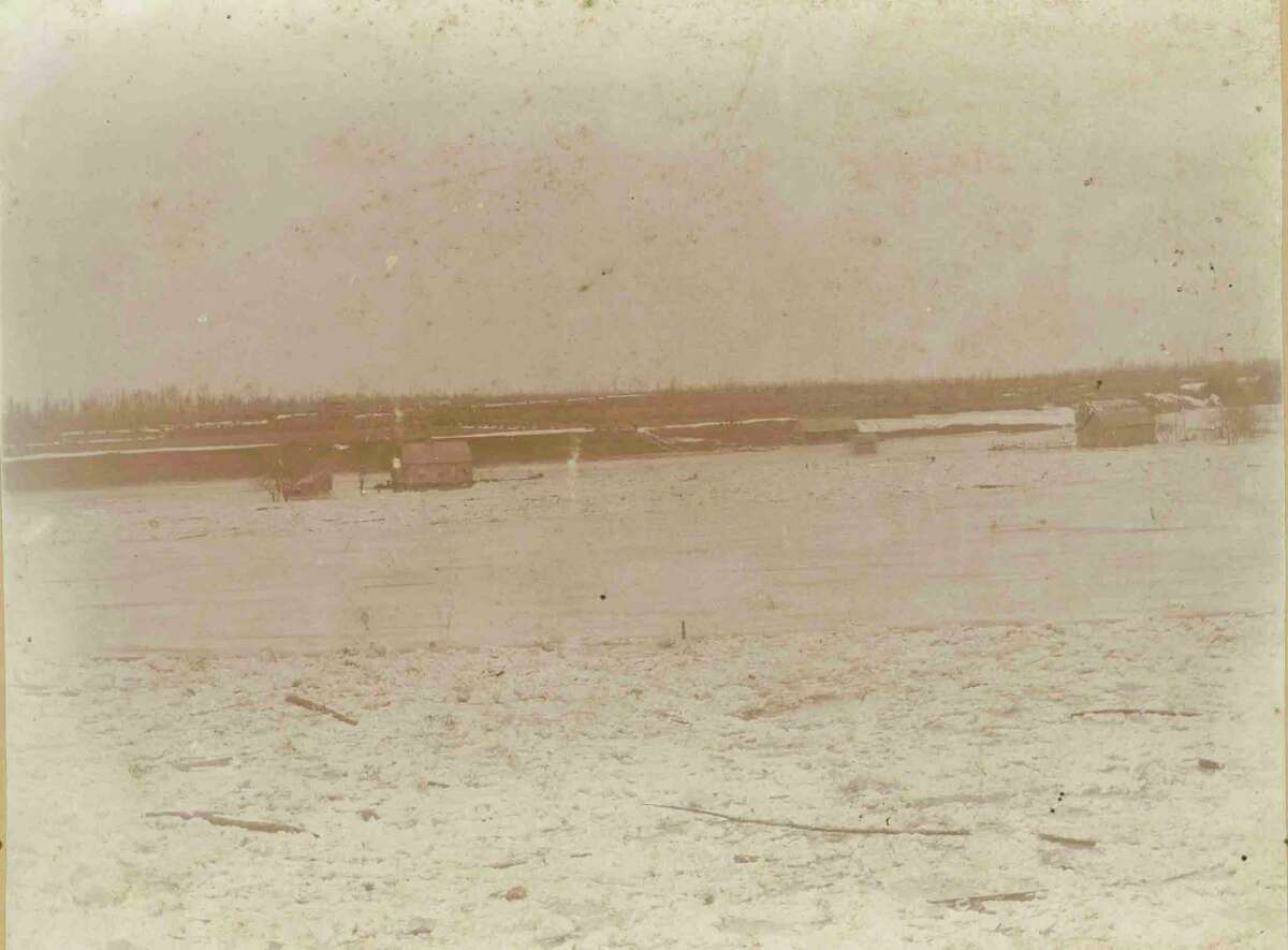 On Sunday, March 12, 1893,huge cakes of river ice began to breakup and rush down the Tittabawassee River, gauging its banks. Larger slabs, measuring up to two and one half feet in thickness, floated over land crashing into houses, barns and trees. (Midland County Historical Society)