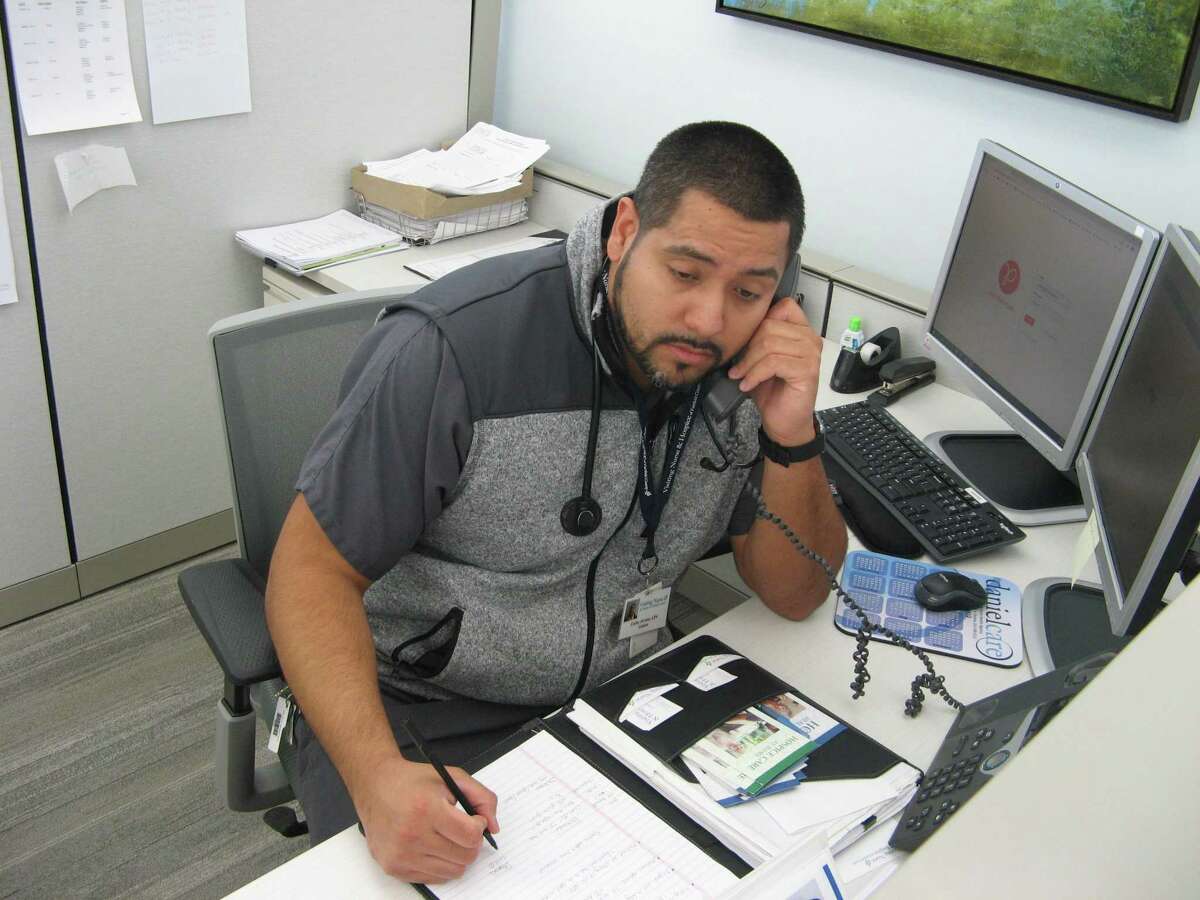Carlos Alvarez, a nurse with Visiting Nurse & Hospice of Fairfield County, takes a call from a member of the community on the agency’s Ask A Nurse hotline. It’s one way the agency has increased its service to the community during the COVID-19 crisis.