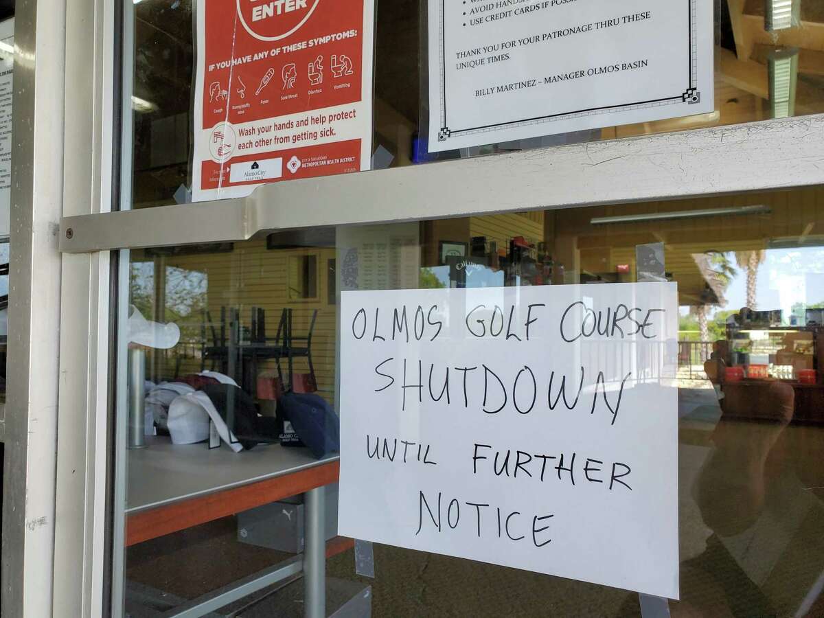 A sign at the clubhouse of Olmos Basin Golf Course, which is closed pending results of a COVID-19 test of an ill employee who cleans golf carts there.