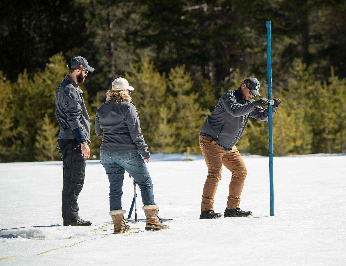 Sean de Guzman (Right), chief of California Department of Water Resources, Snow Surveys and Water Supply Forecasting Section, conducts the third media snow survey of the 2020 season at Phillips Station in the Sierra Nevada Mountains. Nate Burely (Left), with DWR’s Water Resources Engineer, Reservoir Coordinated Operations Section, and Molly White (Center), DWR’s Chief of State Water Project Water Operations Office, assist with the survey, which was held approximately 90 miles east of Sacramento off Highway 50 in El Dorado County. Photo taken February 27, 2020. Ken James / California Department of Water Resources, FOR EDITORIAL USE ONLY