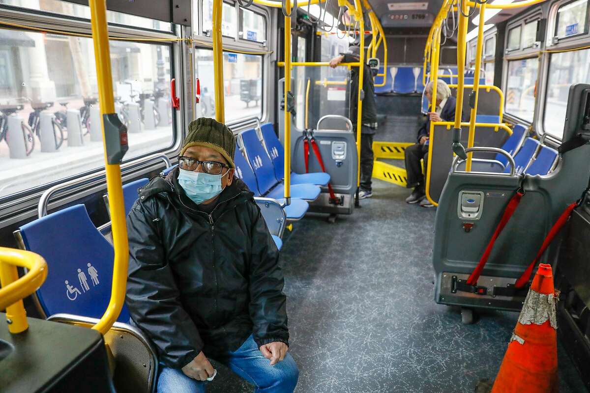 A man rides MUNI down Market Street during the second week of shelter in place orders due to the coronavirus on Sunday, March 29, 2020 in San Francisco, California. Starting Monday, there will be no more subway or light rail service in San Francisco.