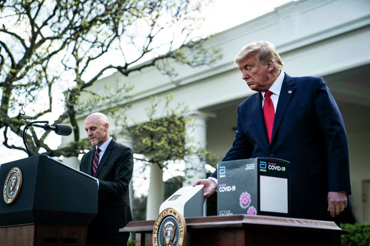 President Donald Trump shows off a new test kit for covid-19 that can produce results in five minutes.
