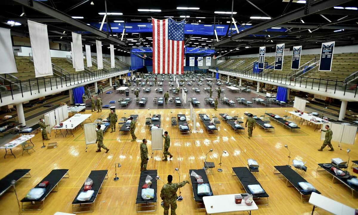 Seventy-five members of the Connecticut National Guard’s 1-102nd Infantry stage a 250-bed medical station Wednesday in the Southern Connecticut State University Moore Field House in New Haven.