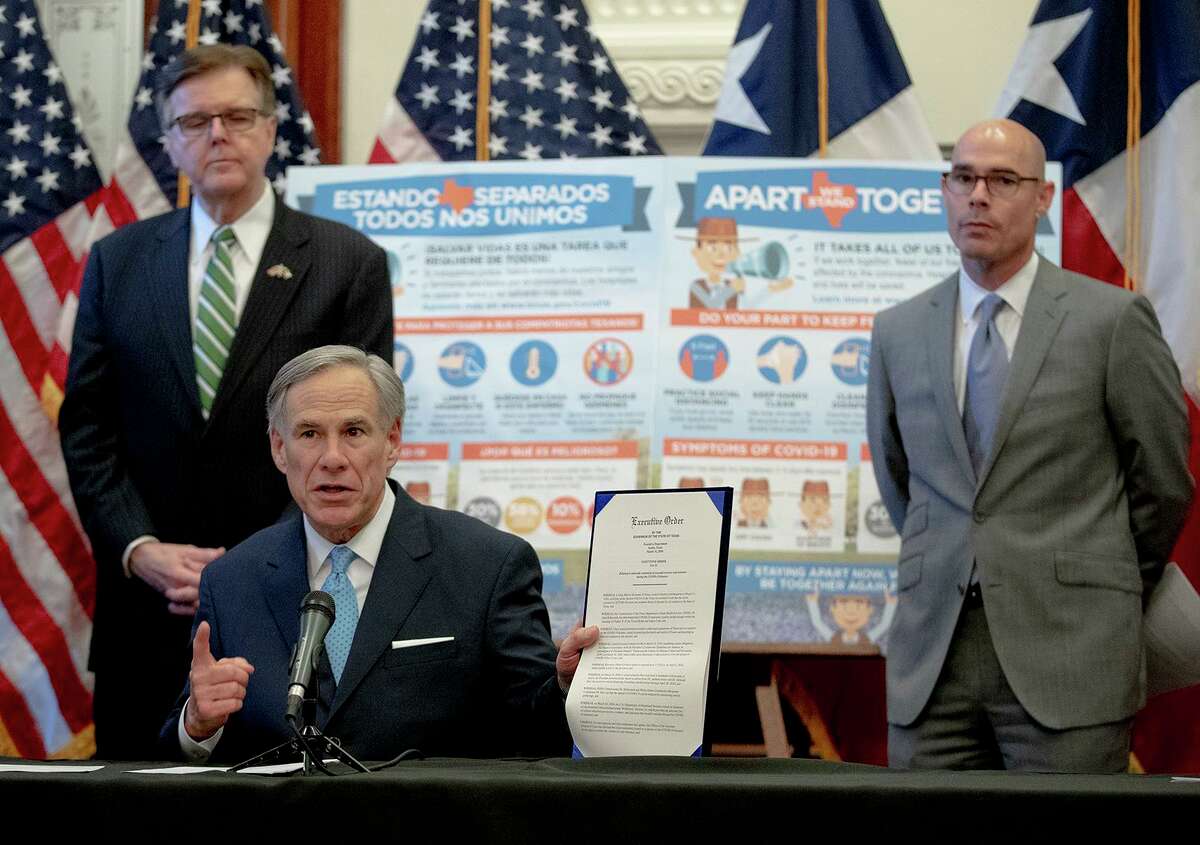 Texas Gov. Greg Abbott, flanked by Lt. Gov. Dan Patrick, left, and House Speaker Dennis Bonnen, speaks during a press conference at the state Capitol about the state's response to the coronavirus on Tuesday, March 31, 2020, in Austin, Texas. (Nick Wagner/Austin American-Statesman via AP)