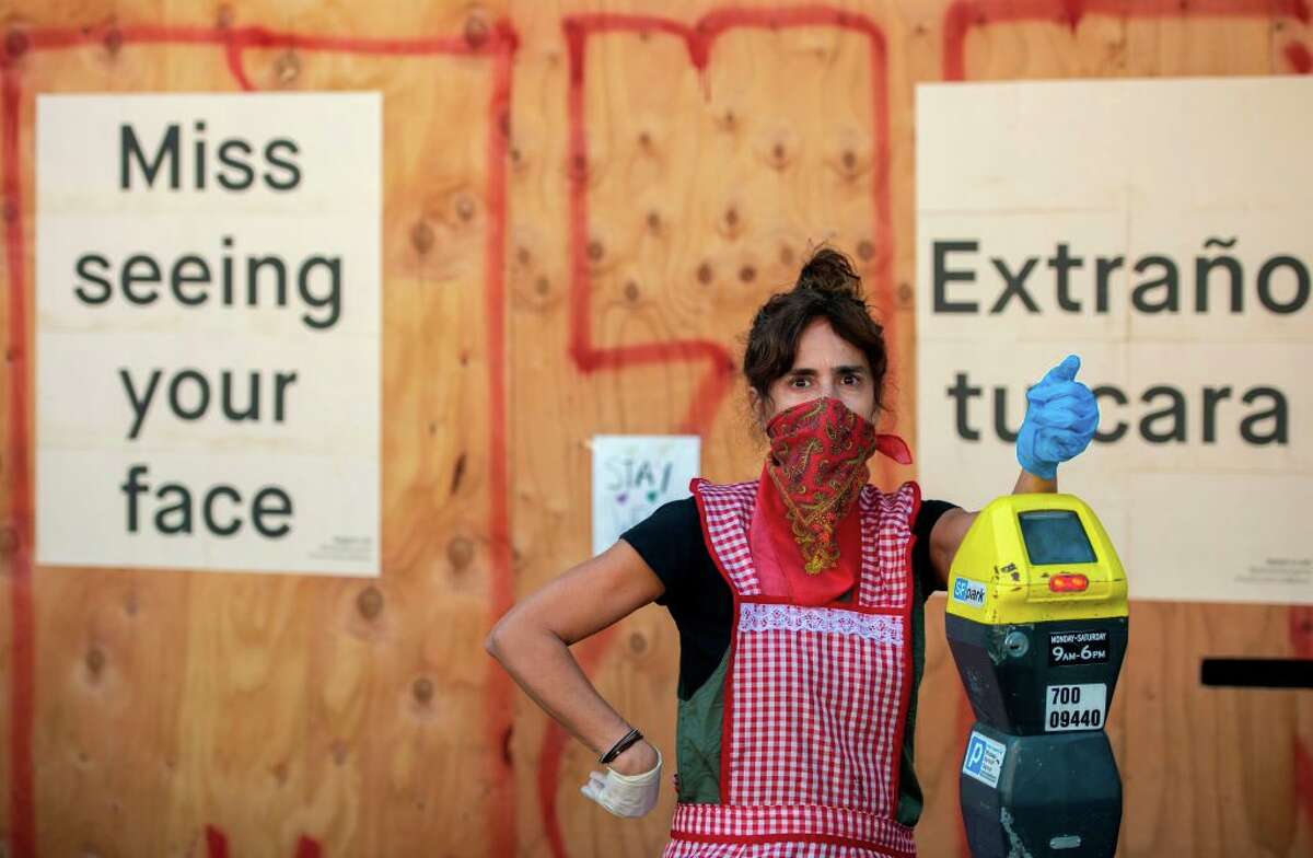 Restaurant owner Lorena Zeruche looks on wearing a bandana on her face as she prepares for take-out only in San Francisco, California on April, 1, 2020, during the novel coronavirus outbreak.