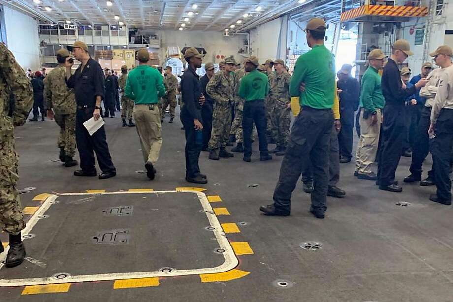 A photo obtained by The Chronicle shows a large amount of crew members congregating Wednesday, April 1, 2020 on the nuclear aircraft carrier U.S.S. Theodore Roosevelt, unable to keep six feet of separation. The captain has said it is impossible to isolate on the warship as they fight a COVID-19 outbreak. Photo: /