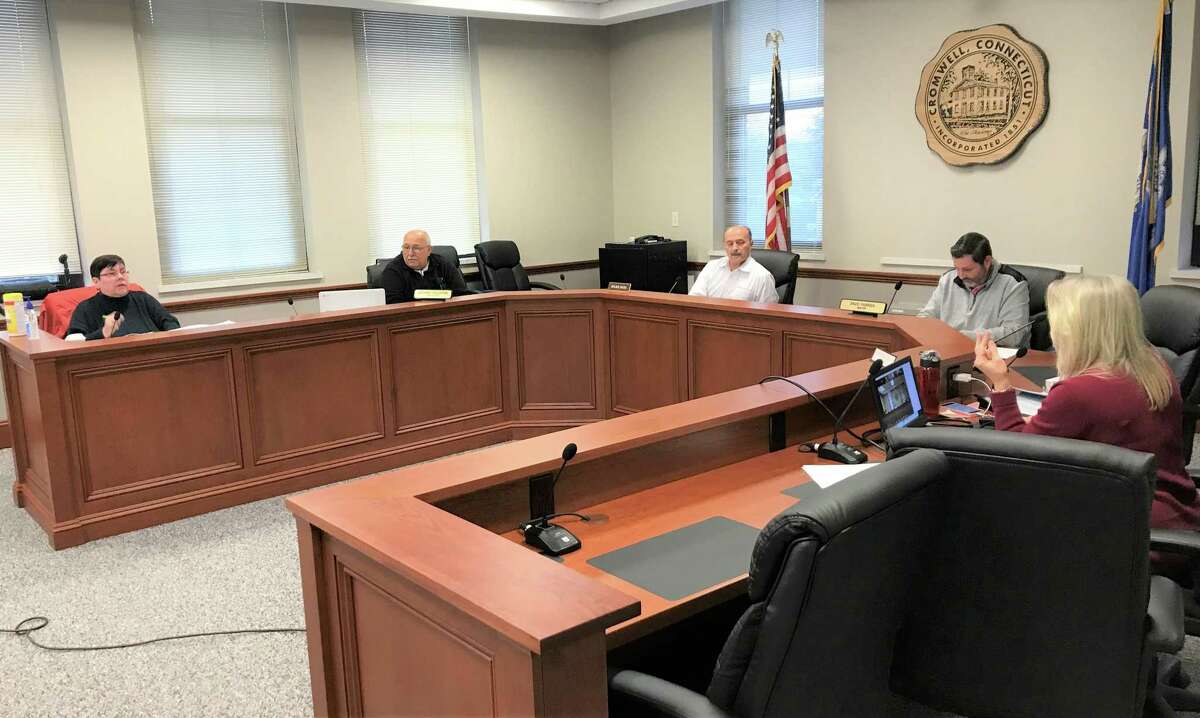 Officials in the Cromwell Town Council Chambers awaiting the start of the Board of Finance meeting  prior to a disturbing attack by hackers. From left they are: Recording Secretary Cynthia Hardacker, Town Manager Anthony J. Salvatore, Board of Finance Chairman Julius C. Neto, Mayor Enzo Faienza and, her back to the camera, Director of of Finance Marianne Sylvester.