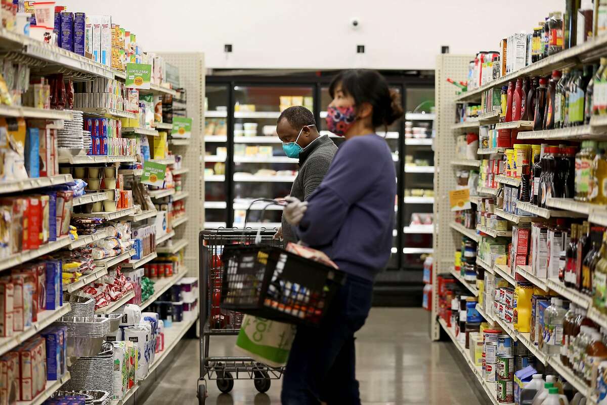 Customers shop at Community Foods Market, located at 3105 San Pablo Ave., on Thursday, April 2, 2020, in Oakland, Calif.
